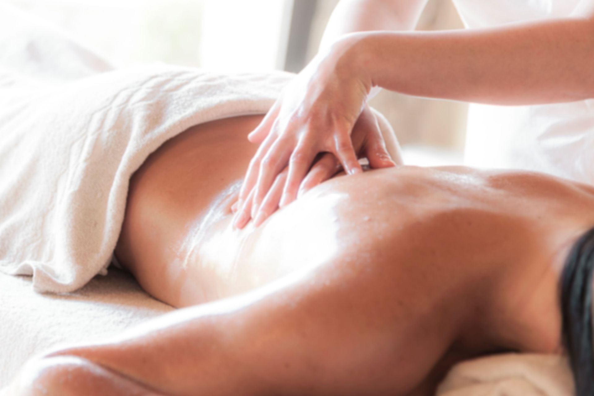 A soothing massage session in a serene spa environment promoting relaxation and wellness.