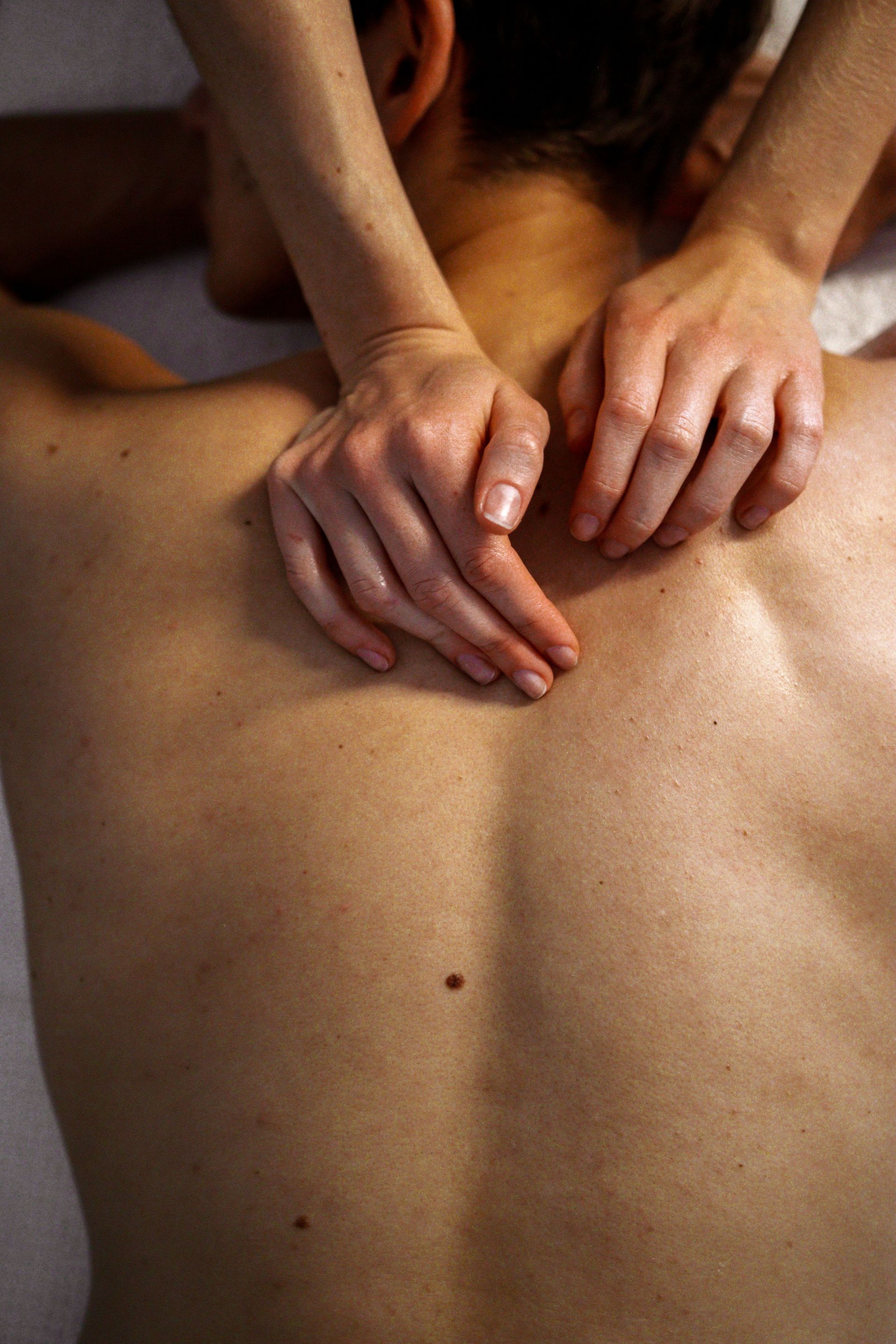 High-angle view of a soothing back massage therapy session highlighting expert hand techniques.
